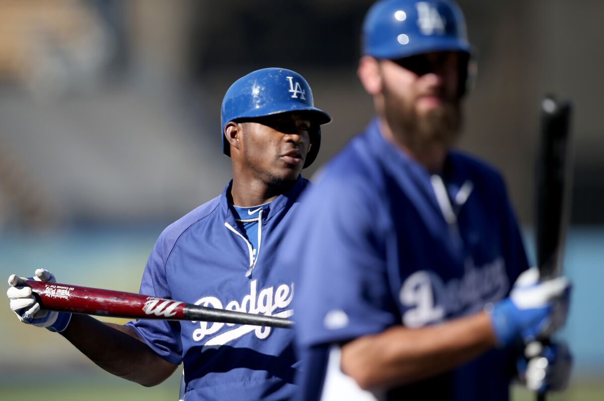 Dodgers outfielders Yasiel Puig and Sott Van Slyke take batting practice before a game againsts the Padres on Aug. 21, 2014.