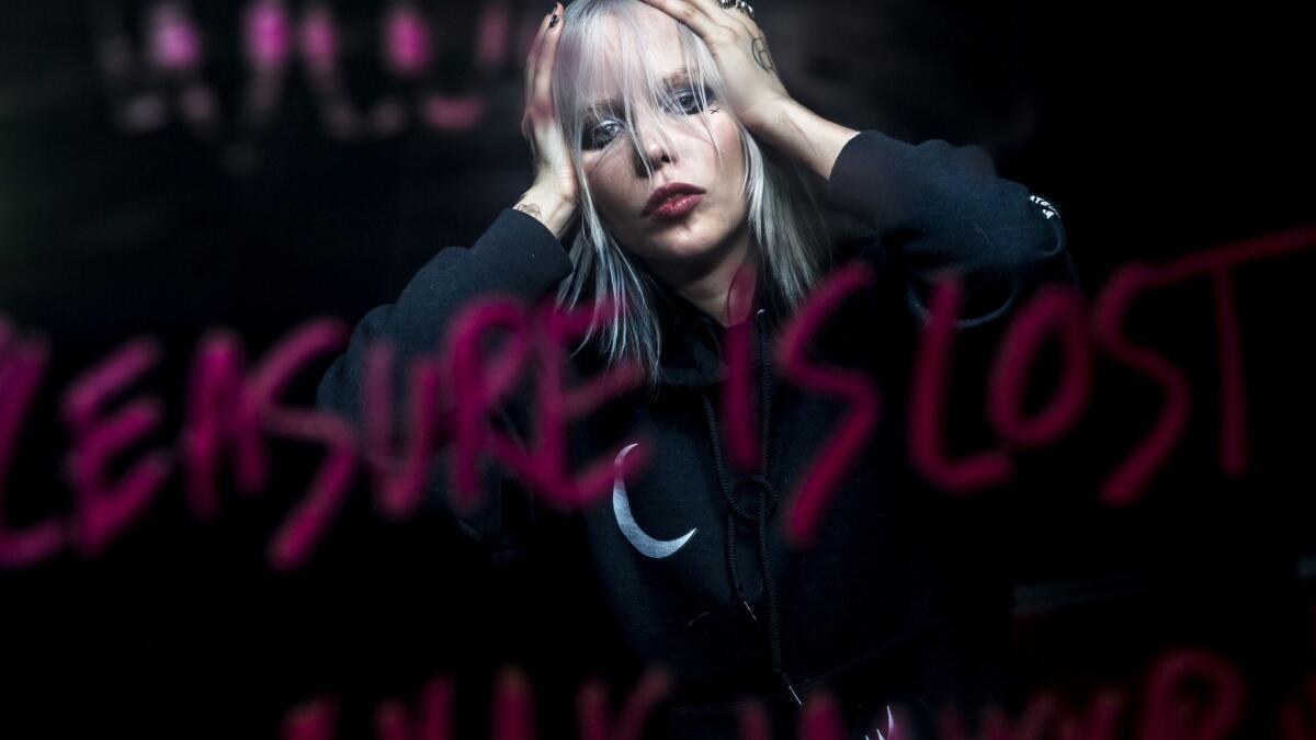 Alice Glass reflected in a mirror with lipstick text for an earlier video project.