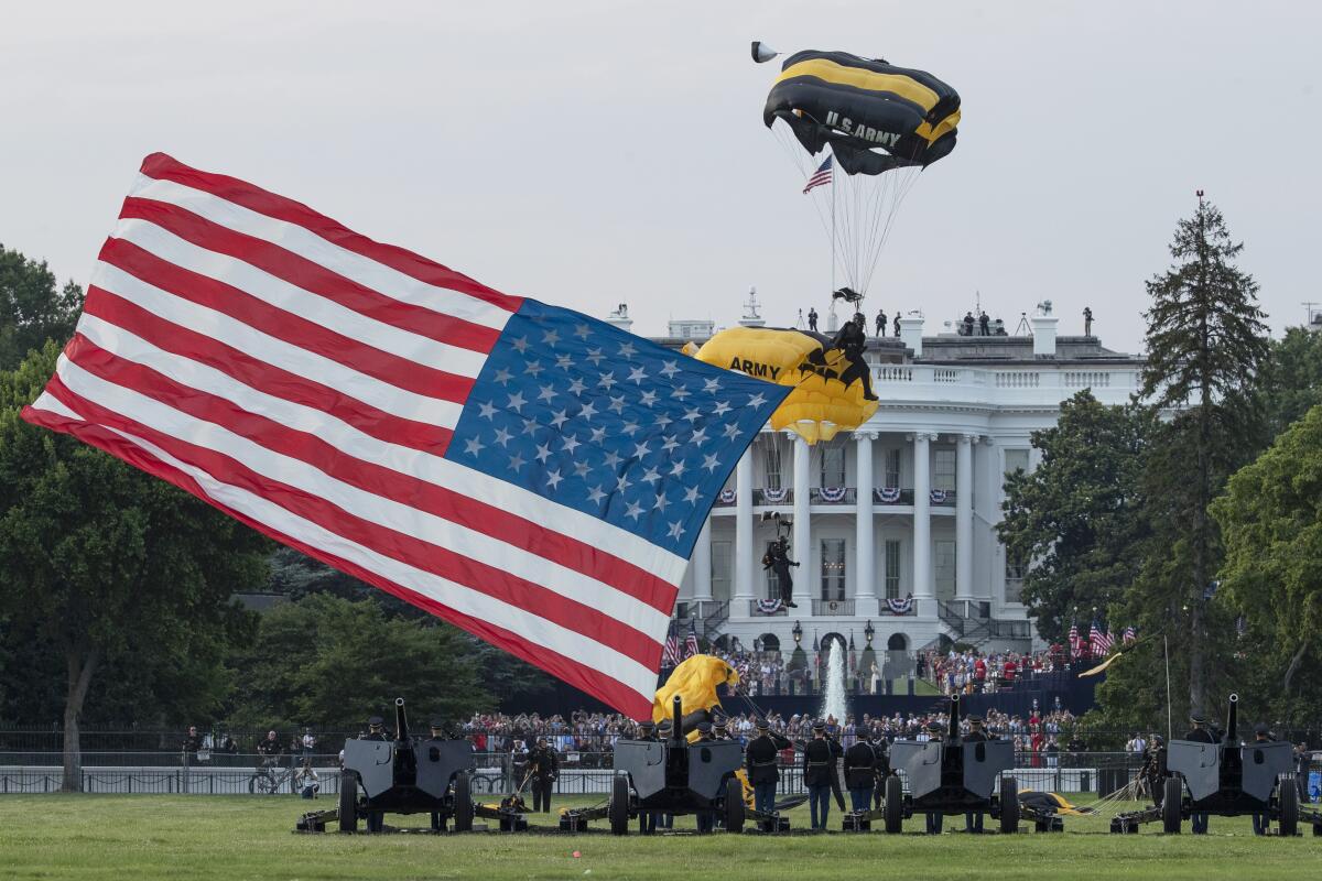 The U.S. Army Golden Knights parachute team descends during a July Fourth event on the South Lawn of the White House.