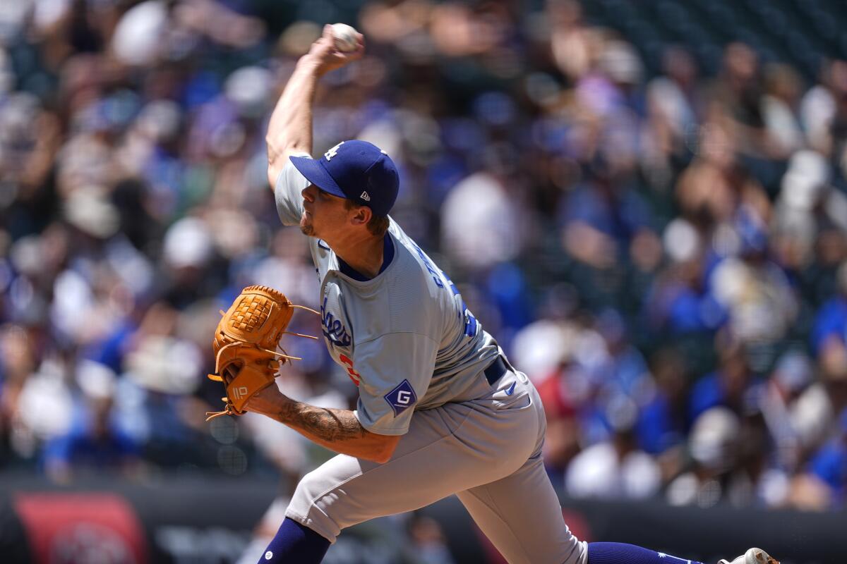Dodgers right-hander Gavin Stone pitches in a gray away uniform at Denver's Coors Field