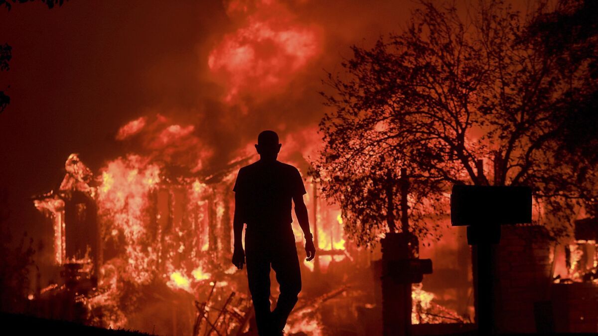 Jim Stites watches part of his neighborhood burn in Fountaingrove during the wildfires that swept through Northern California in October 2017.