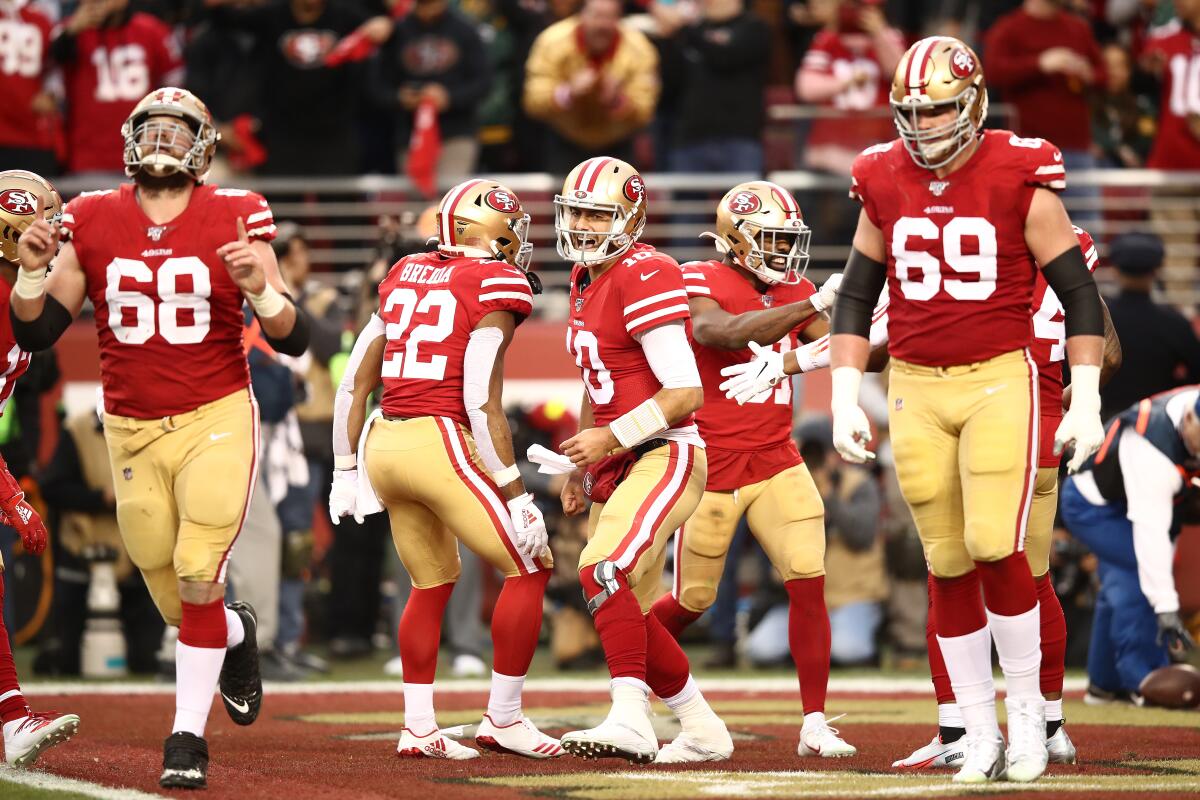 Jimmy Garoppolo (10) and the Super Bowl-bound San Francisco 49ers celebrate after a touchdown against the Green Bay Packers on Jan. 19 at Levi's Stadium. 