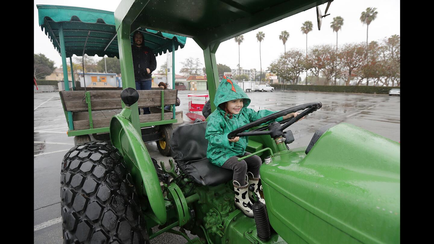 Cordelia Flynn, 3, of Costa Mesa, plays with a tractor truck steering wheel during the inaugural Touch-a-Truck event at the Orange County Market Place on Saturday, March 10.