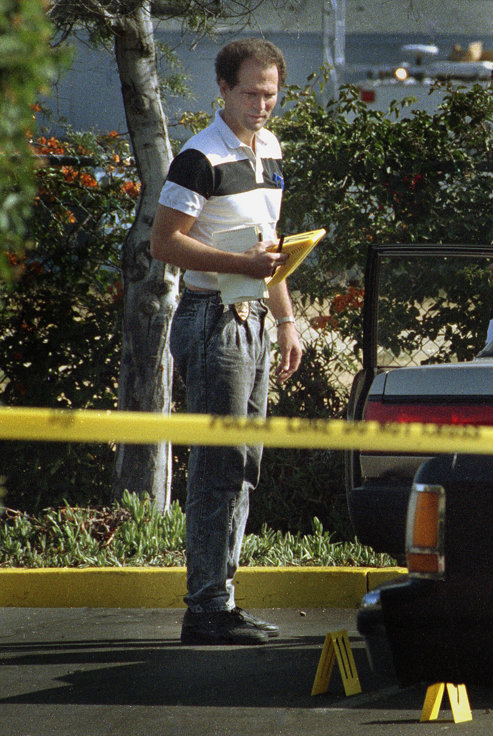 San Diego Police Department criminalist Kevin Brown works at a crime scene in 1991.