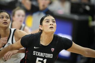 Stanford center Lauren Betts blocks out and looks up during a basketball game