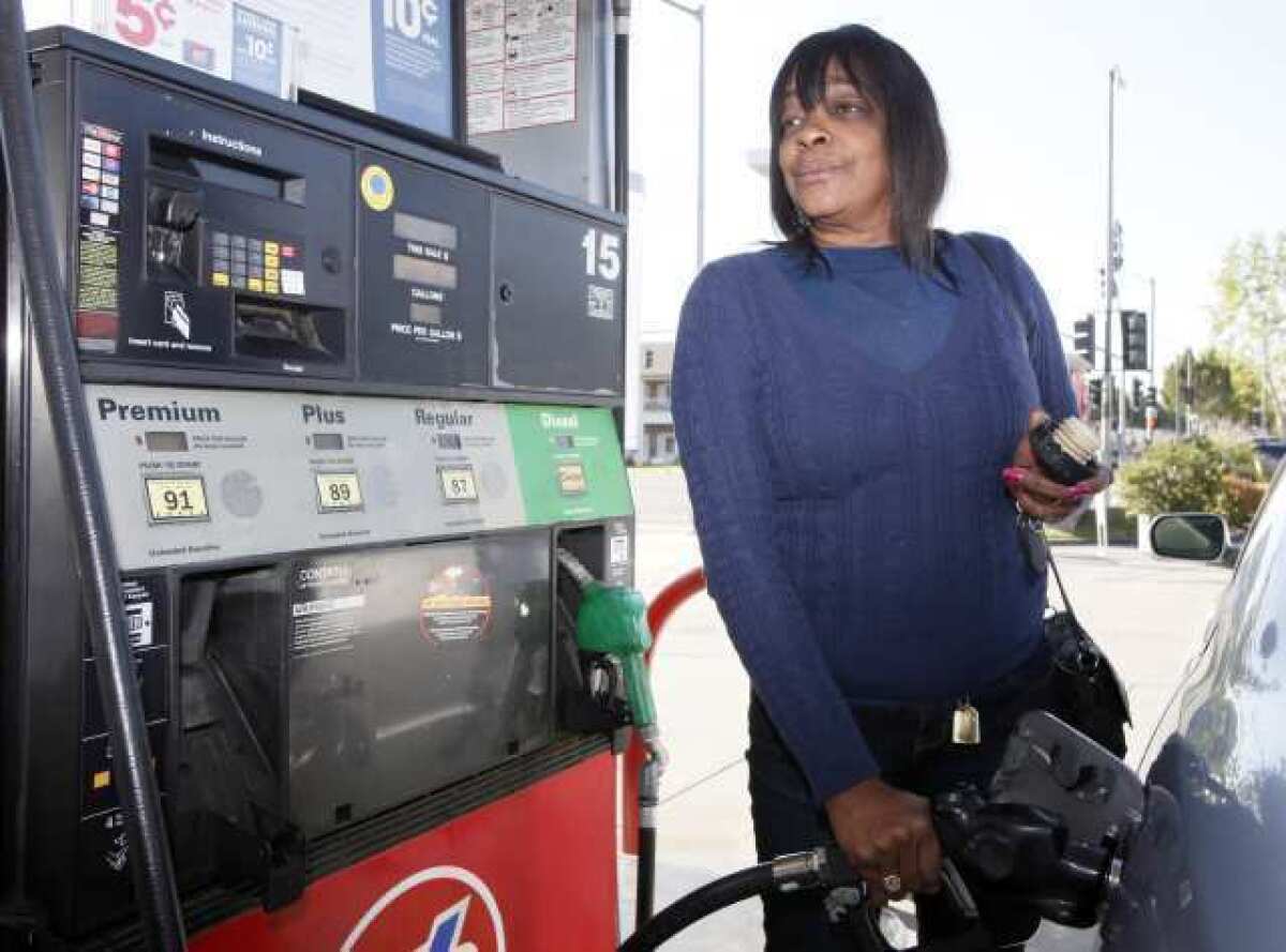 Rosalyn Buchanan fills her tank with gas at a station in Arcadia, Calif. From all corners of the country, Americans are poorer and angrier these days, thanks to the record fuel prices that have soared above $4 a gallon in some states and could top $5 by summer.