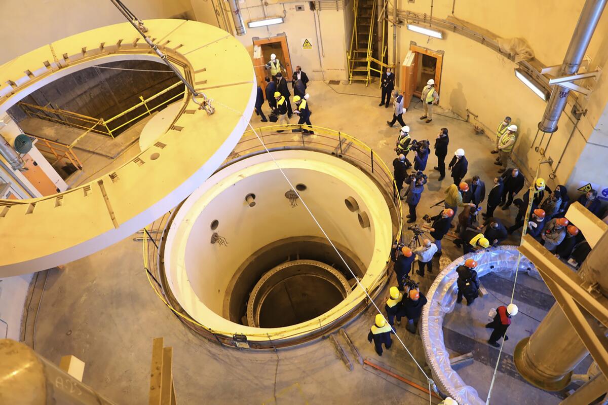 Technicians work at the Arak heavy water reactor as officials and media visit 