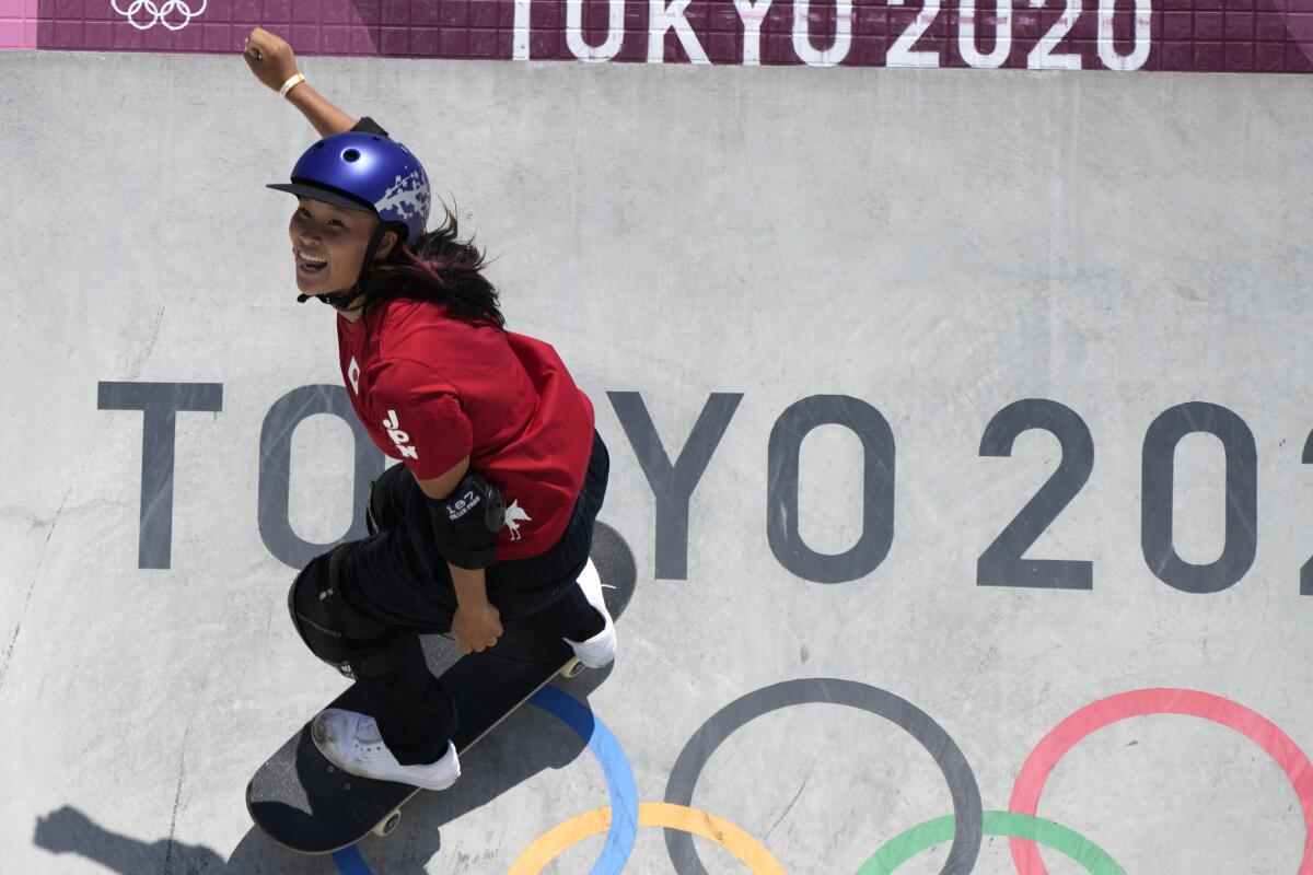 A skateboarder with a helmet performs