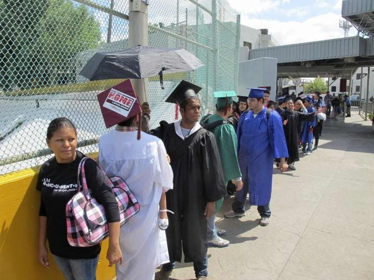 Immigration activists wearing graduation caps and gowns try to enter the U.S. in Laredo, Texas.
