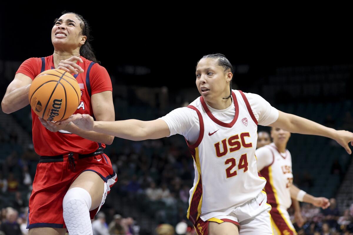 USC forward Kaitlyn Davis, right, attempts to steal the ball from Arizona forward Esmery Martinez.