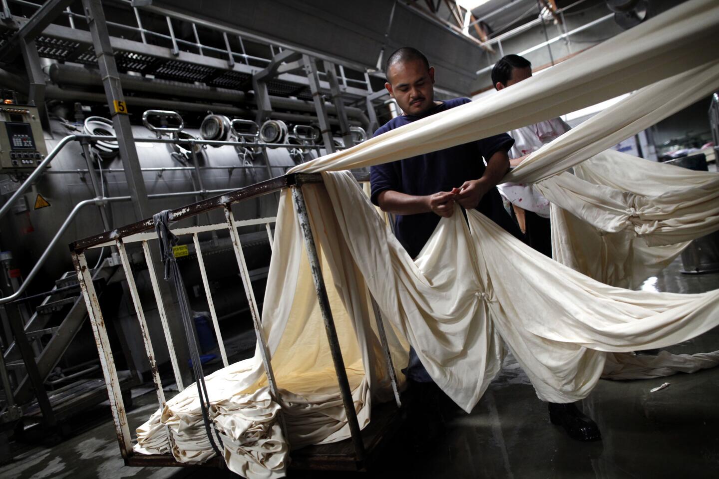 American Apparel employees handle cloth at the company's manufacturing plant in downtown Los Angeles.