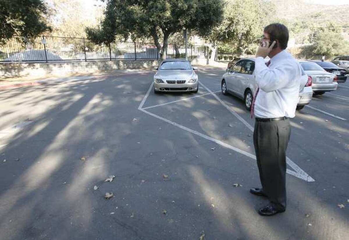 Dr. Richard Sheehan stands in a nearly empty parking lot making a call on his cell phone attempting to locate where in Verdugo Park the Glendale PTA gathered to show their support for Proposition 38. It turned out he was at the opposite end of the park.