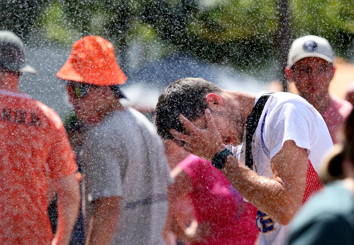 A fan tries to stay cool while attending the Paris Olympics tennis tournament at Roland Garros on Wednesday.