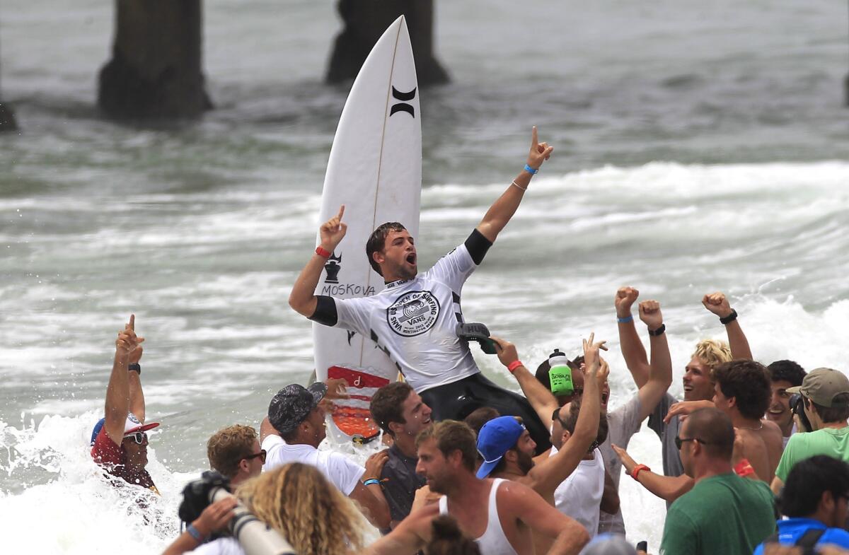 Alejo Muniz celebrates as he's carried onto the beach after winning the U.S. Open of Surfing in Huntington Beach on Sunday.