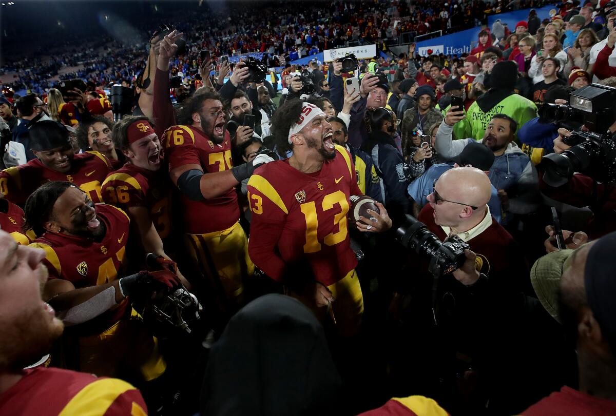 USC quarterback Caleb Williams, center, celebrates with teammates after the Trojans' 48-45 win.