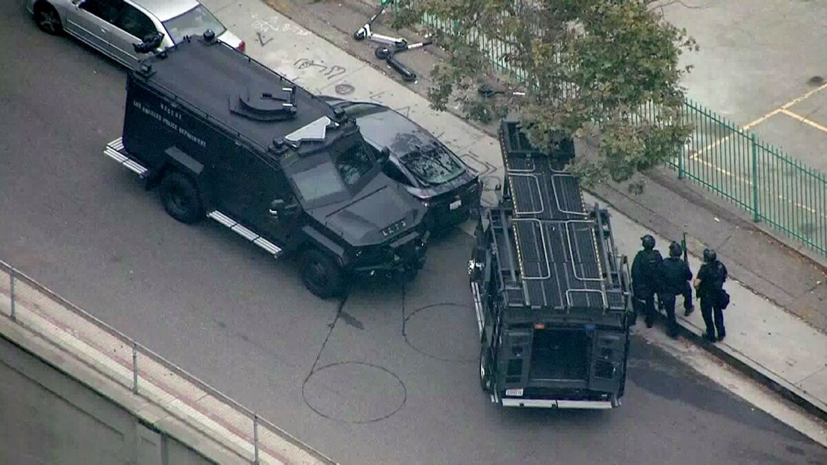 LAPD SWAT officers approach a Toyota Prius.