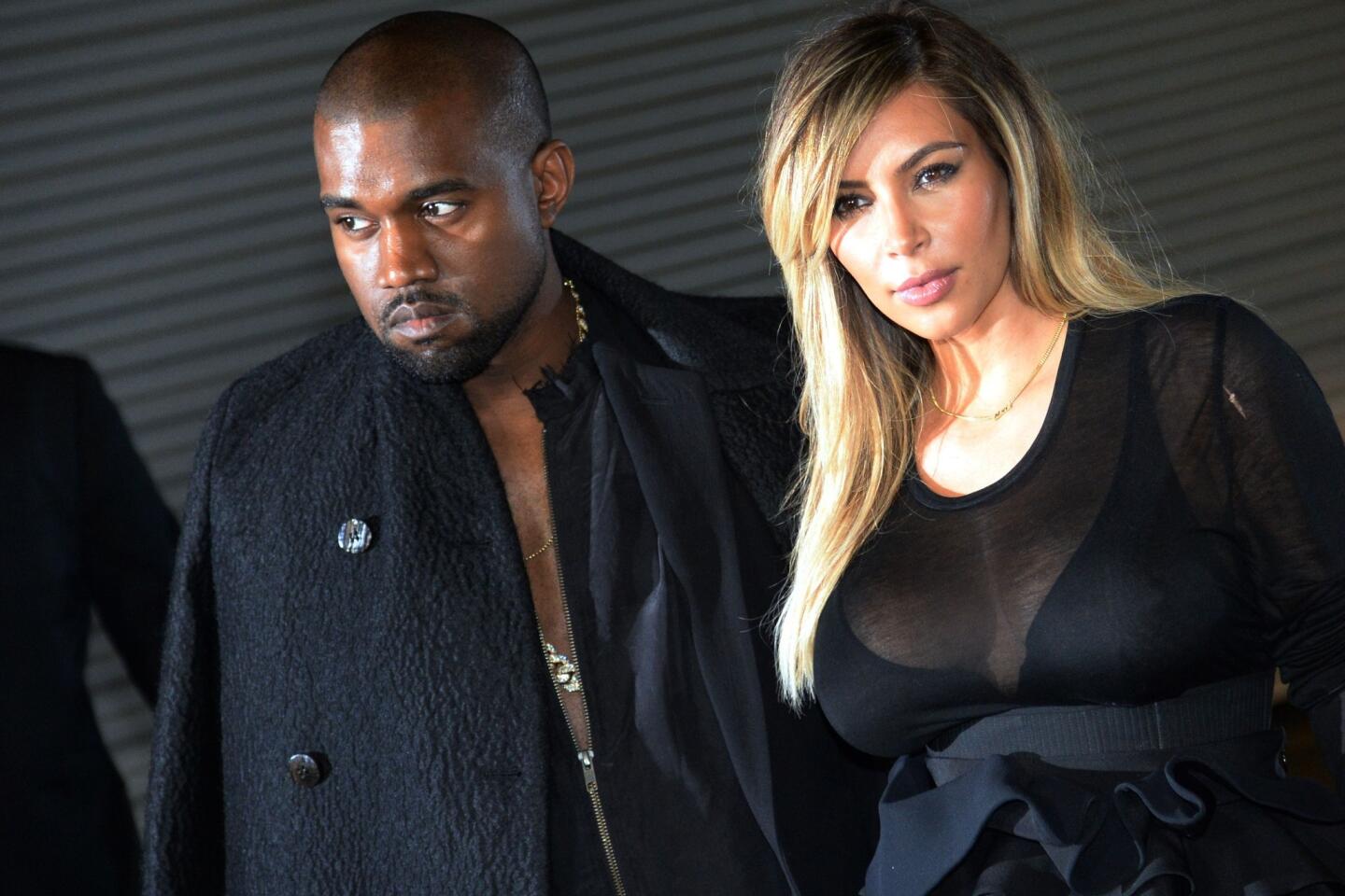 Musician Kanye West and girlfriend Kim Kardashian at the Givenchy 2014 spring-summer ready-to-wear collection fashion show on Sept. 29, 2013, in Paris.