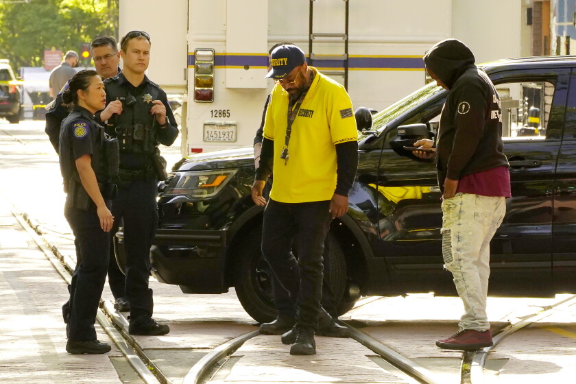 Frank Turner, center, turns away after Sacramento police officers refused to allow him to look for his son.