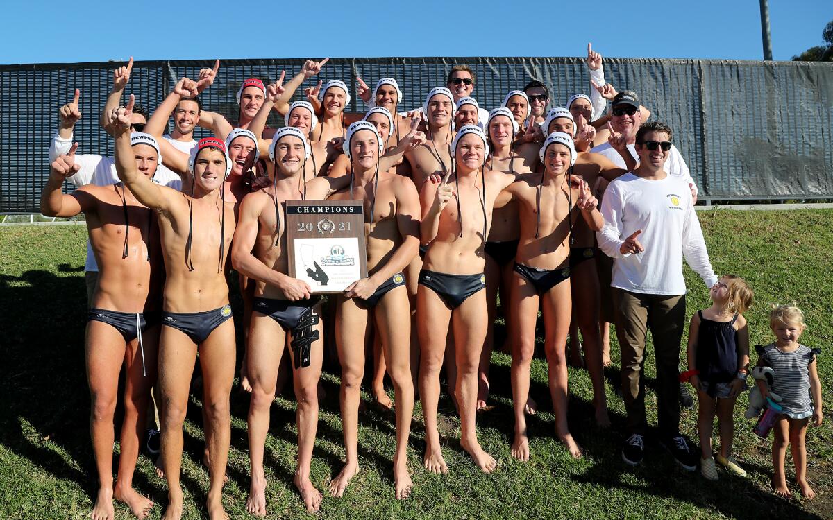 The Newport Harbor boys' water polo team poses with the championship plaque Saturday afternoon.