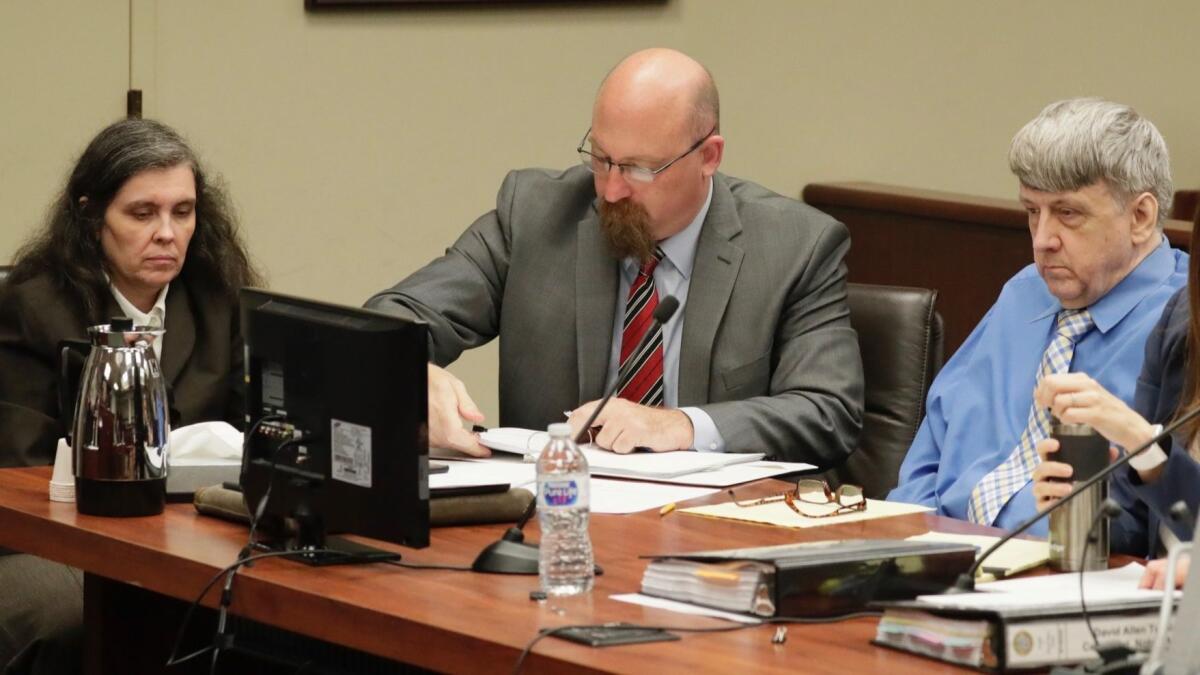 Louise Turpin, left, and David Turpin, right, at their preliminary hearing Wednesday in Riverside. The Perris couple face dozens of charges related to the alleged mistreatment of their 13 children.