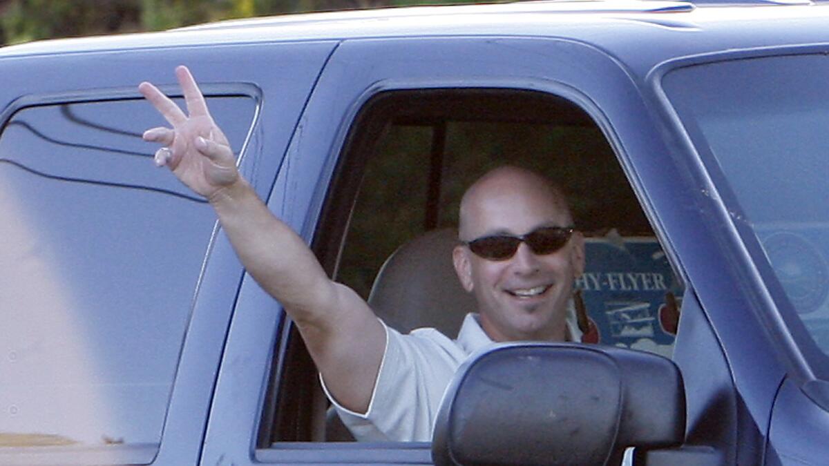 Bruce Lisker waves to a phalanx of media waiting at the front entrance of Mule Creek State Prison minutes after he was released from prison in 2009.