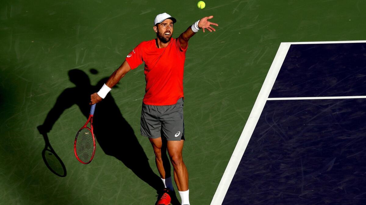 Steve Johnson serves to Taylor Fritz during the BNP Paribas Open at the Indian Wells Tennis Garden on Friday.