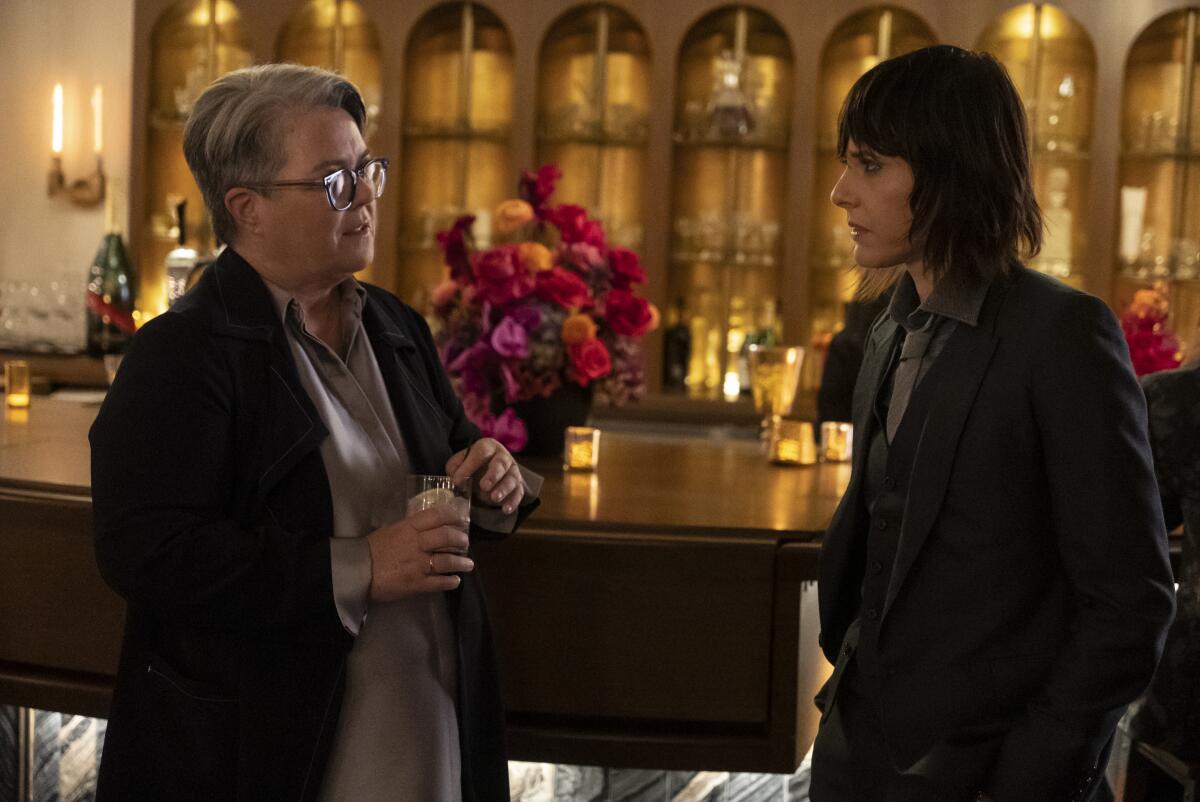 Two women talking at a bar