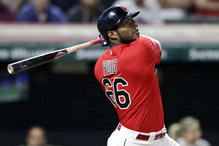 FILE - In this Sept. 18, 2019, file photo, Cleveland Indians' Yasiel Puig watches his hit.