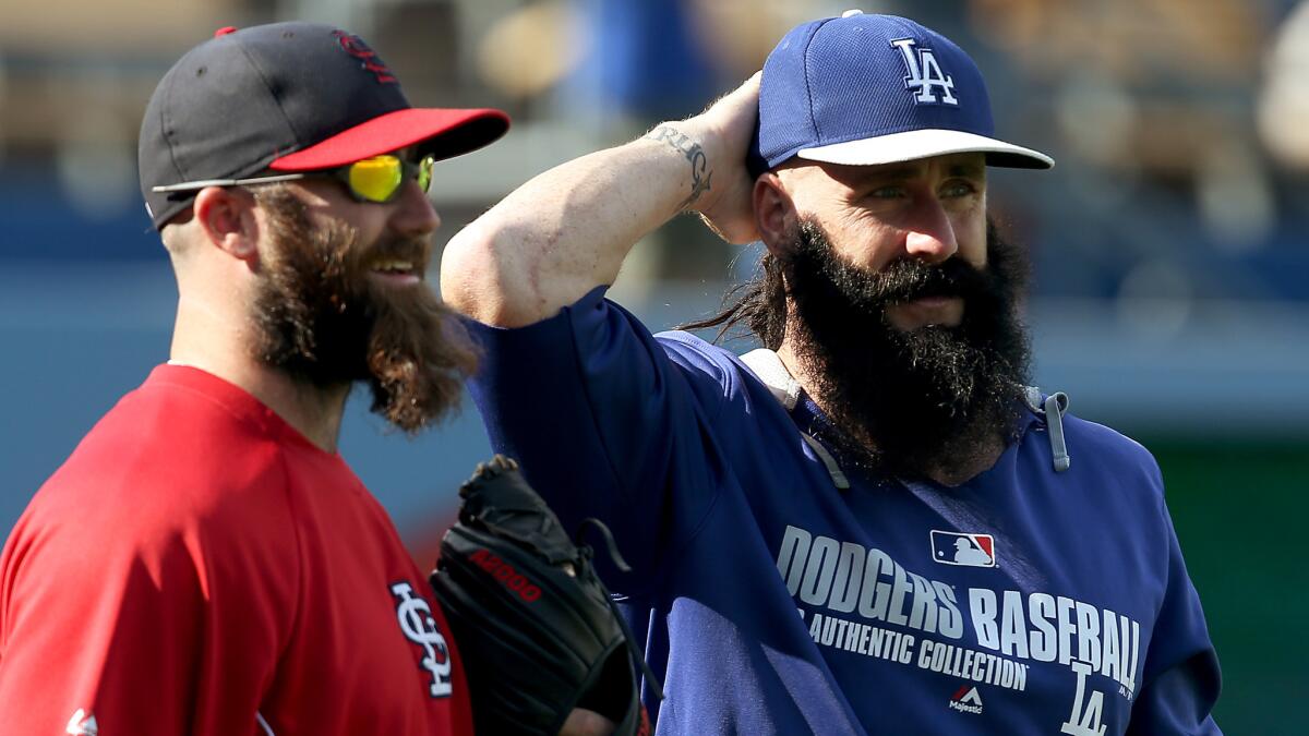 St. Louis Cardinals pitcher Jason Motte, left, and Dodgers reliever Brian Wilson converse before a game at Dodger Stadium in June.
