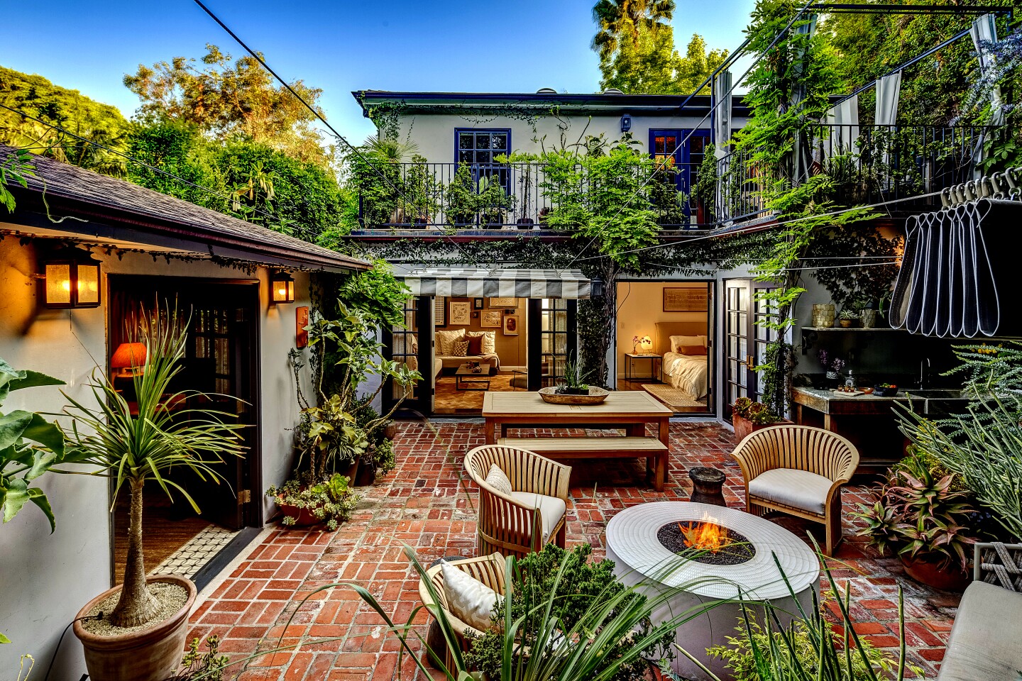 Time spent living in Mexico City was a driving force behind the renovation of this 1930s traditional home in West Hollywood. The home's lush backyard was designed as a series of small outdoor rooms and features intimate sitting areas, a small outdoor kitchen and an outdoor audio system for entertaining. Terra cotta planters and clay pottery crafted by Mexican artists dot the backyard. Upstairs, the master suite opens to a private garden balcony. Inside, the home, priced at $2.299 million, has hardwood floors, a living room with a fireplace and an updated kitchen.