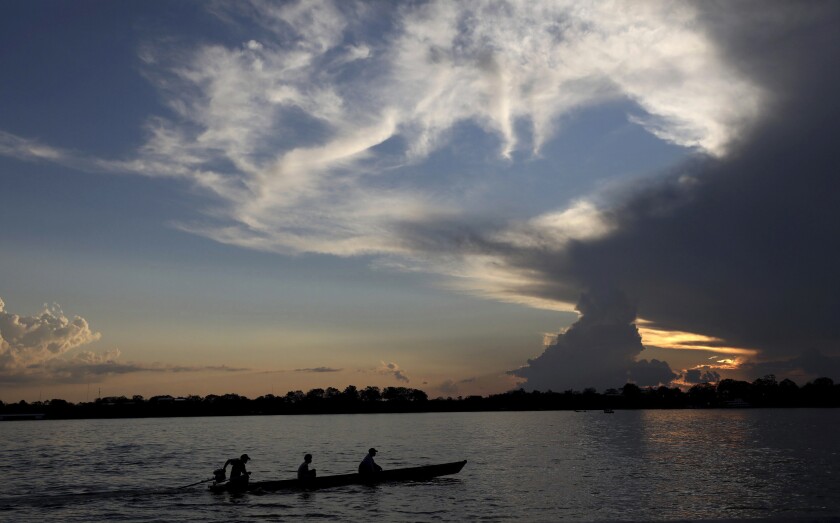 FILE - Local residents navigate the Amazon River near Leticia, Colombia, Sept. 7, 2019. Gustavo Petro, Colombia's first elected leftist president, will take office in August with ambitious proposals to halt the record-high rates of deforestation in the Amazon. (AP Photo/Fernando Vergara, File)