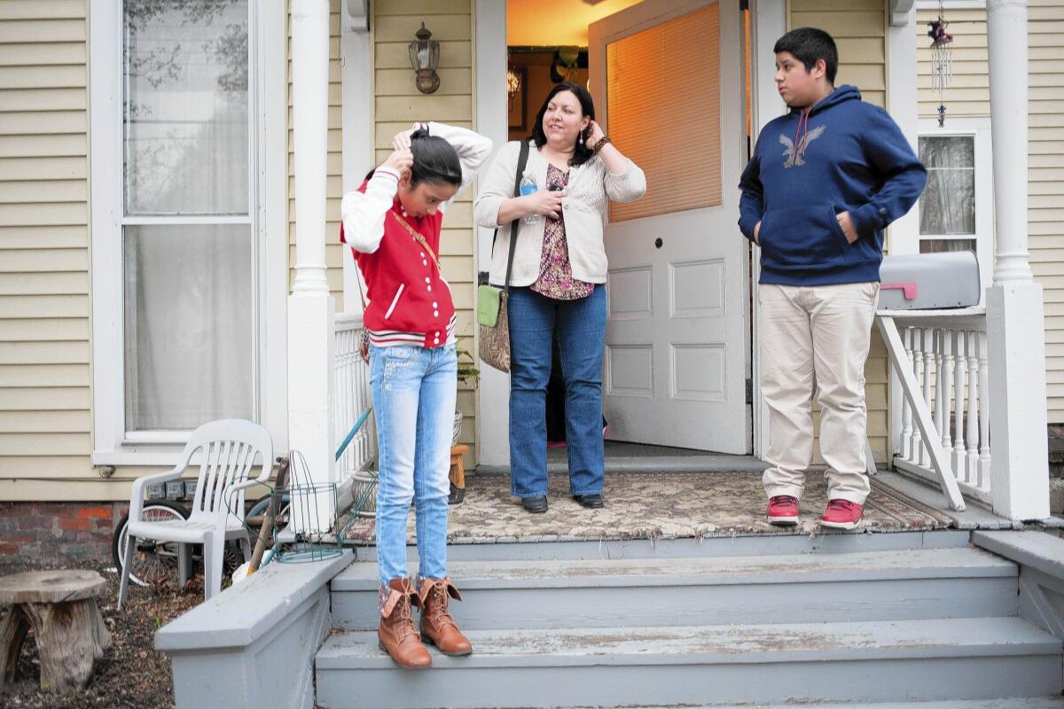 Activist Veronica Isabel Dahlberg talks with Diona, 12, and Cristian Ramos, 14, whose father was in immigration detention and close to being deported in March, when Dahlberg helped keep him in the country.