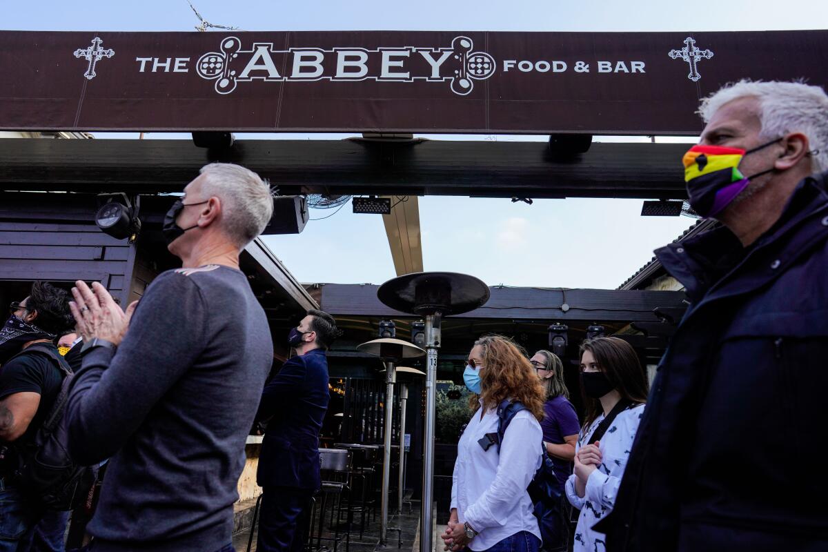 Supporters of area restaurants listen to a news conference.