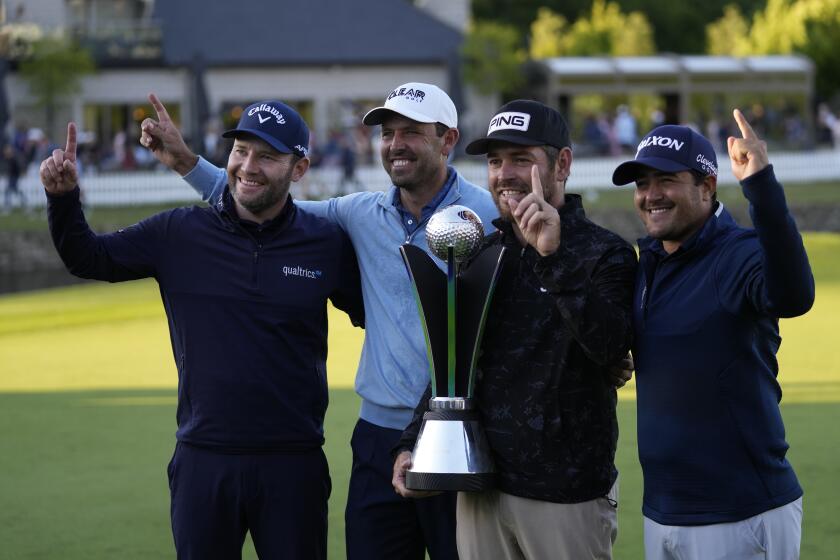 Team Stinger winners of the team events pose foe the media with their trophy on the 18th green, from the left Branden Grace of South Africa, Charles Schwartzel of South Africa, Louis Oosthuizen of South Africa, and Hennie Du Plessis of South Africa after the presentation ceremony at the inaugural LIV Golf Invitational at the Centurion Club in St Albans, England, Saturday, June 11, 2022. (AP Photo/Alastair Grant)