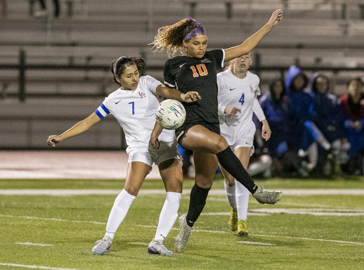 Los Alamitos' Viviana Zacarias and Huntington Beach's Jaiden Anderson battle for a ball during a Surf League match on Monday.