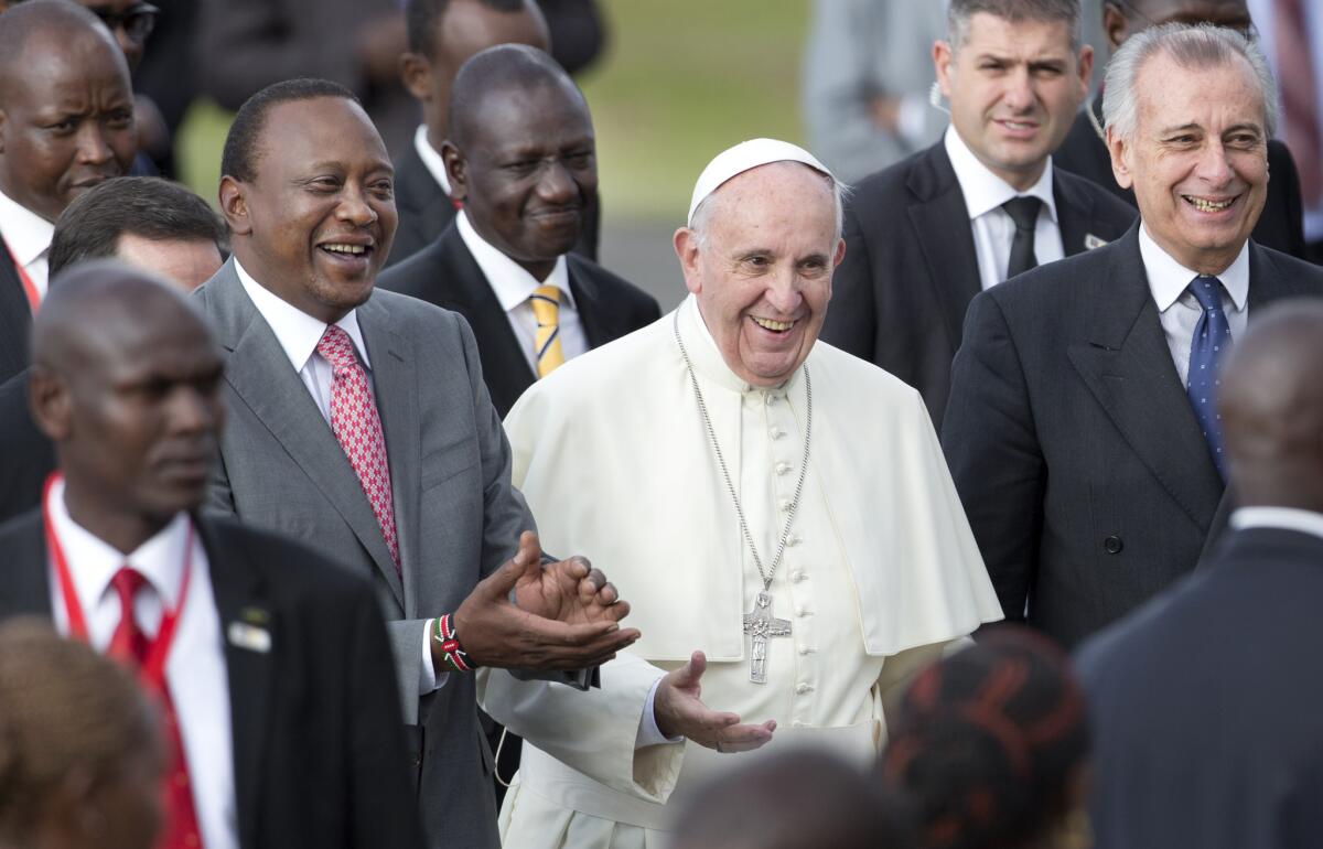 Pope Francis is accompanied by Kenyan President Uhuru Kenyatta, left, and Deputy President William Ruto, second from left, in Nairobi on Nov. 25.