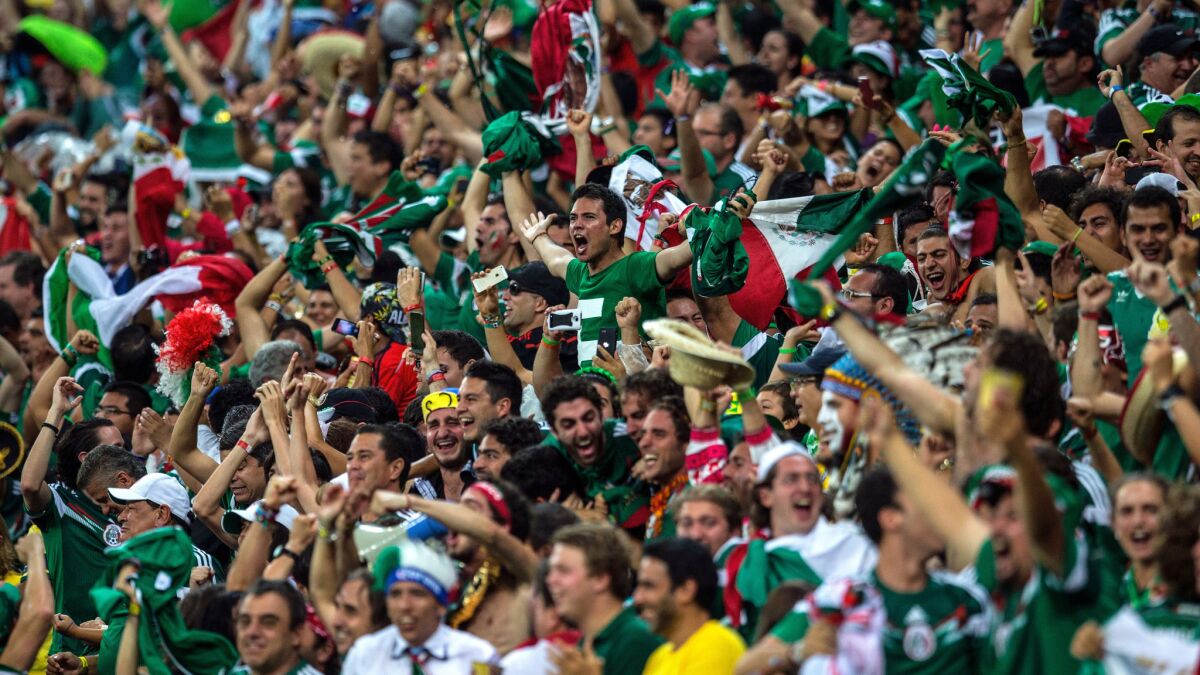 Mexico fans celebrate a goal during the team's 3-1 World Cup win over Croatia on Monday.