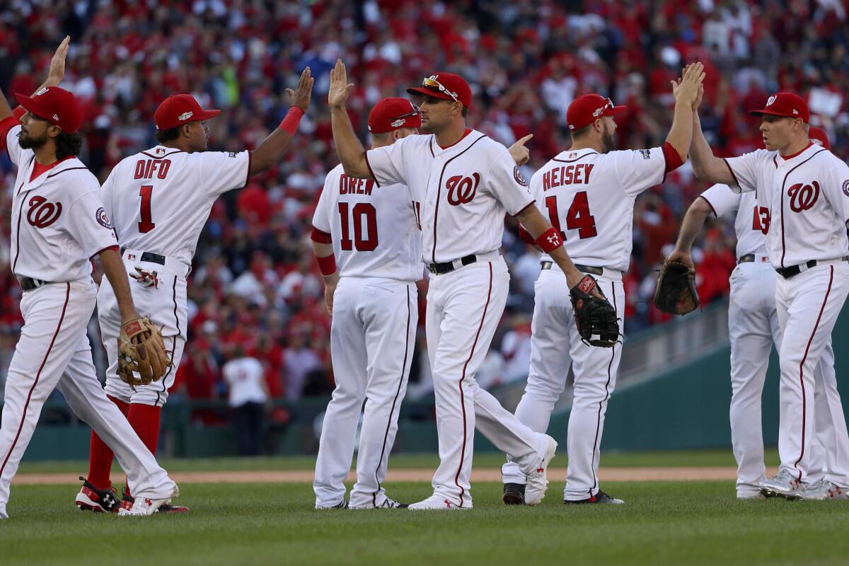 The Nationals congratulate each other after their 5-2 victory.