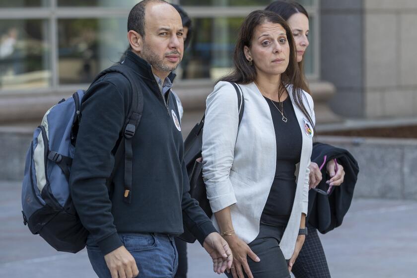 VAN NUYS, CA-APRIL 25, 2022: Nancy Iskander and her husband Karim leave Van Nuys Courthouse during a lunch break from a preliminary hearing for Rebecca Grossman who is charged with murder and other counts stemming from a crash in Westlake Village that left the Iskander's sons Mark Iskander, 11, and Jacob Iskander, 8, dead. Nancy Iskander took the witness stand and testified to the moment her sons were killed by Grossman's Mercedes as they were walking in the crosswalk on Triunfo Canyon Rd. In. Westlake. Village. (Mel Melcon / Los Angeles Times)