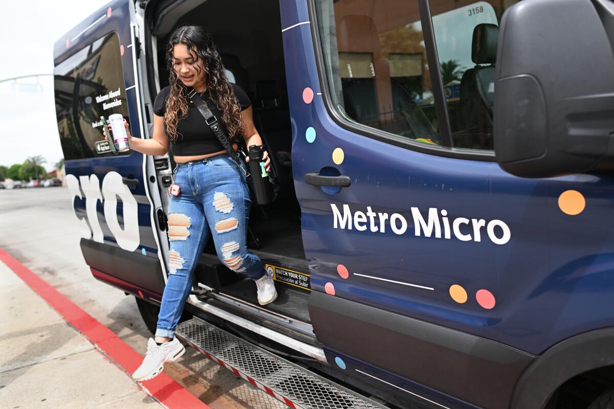 A woman steps off a van.