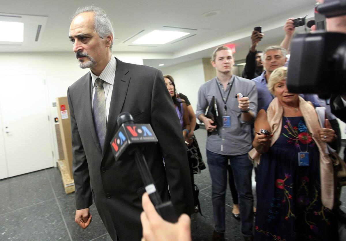 Syrian ambassador to the United Nations Bashar Jaafari departs after speaking to reporters outside the U.N. Security Council in New York. "We are in a state of war right now, preparing ourselves for the worst scenario," he said.