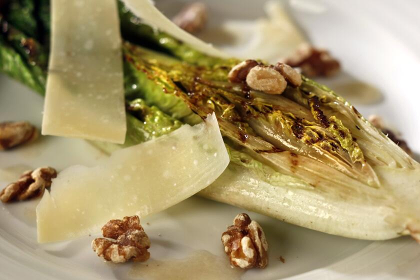 Grilled romaine lettuce with walnuts, Parmesan and anchovy dressing
