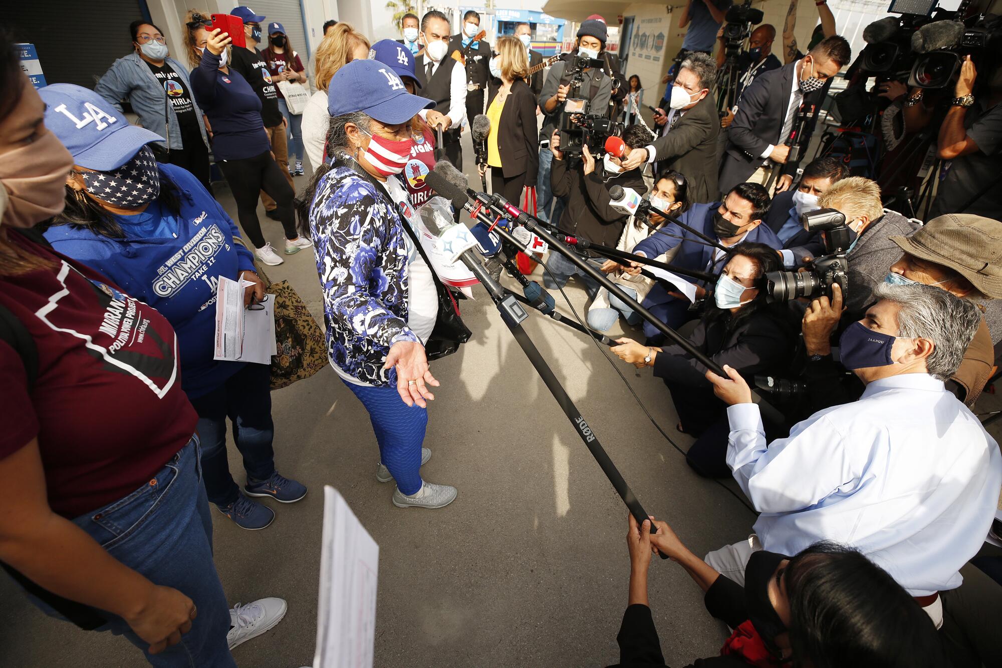 Salvadora Martir, 73, talks to the media after she voted for the first time as a new U.S. citizen at Dodger Stadium