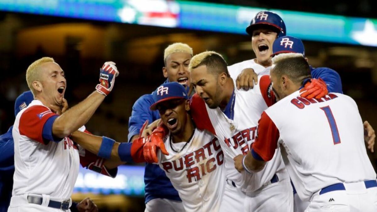 Puerto Rico team members celebrate their win over the Netherlands in a World Baseball Classic semifinal at Dodger Stadium on March 20.