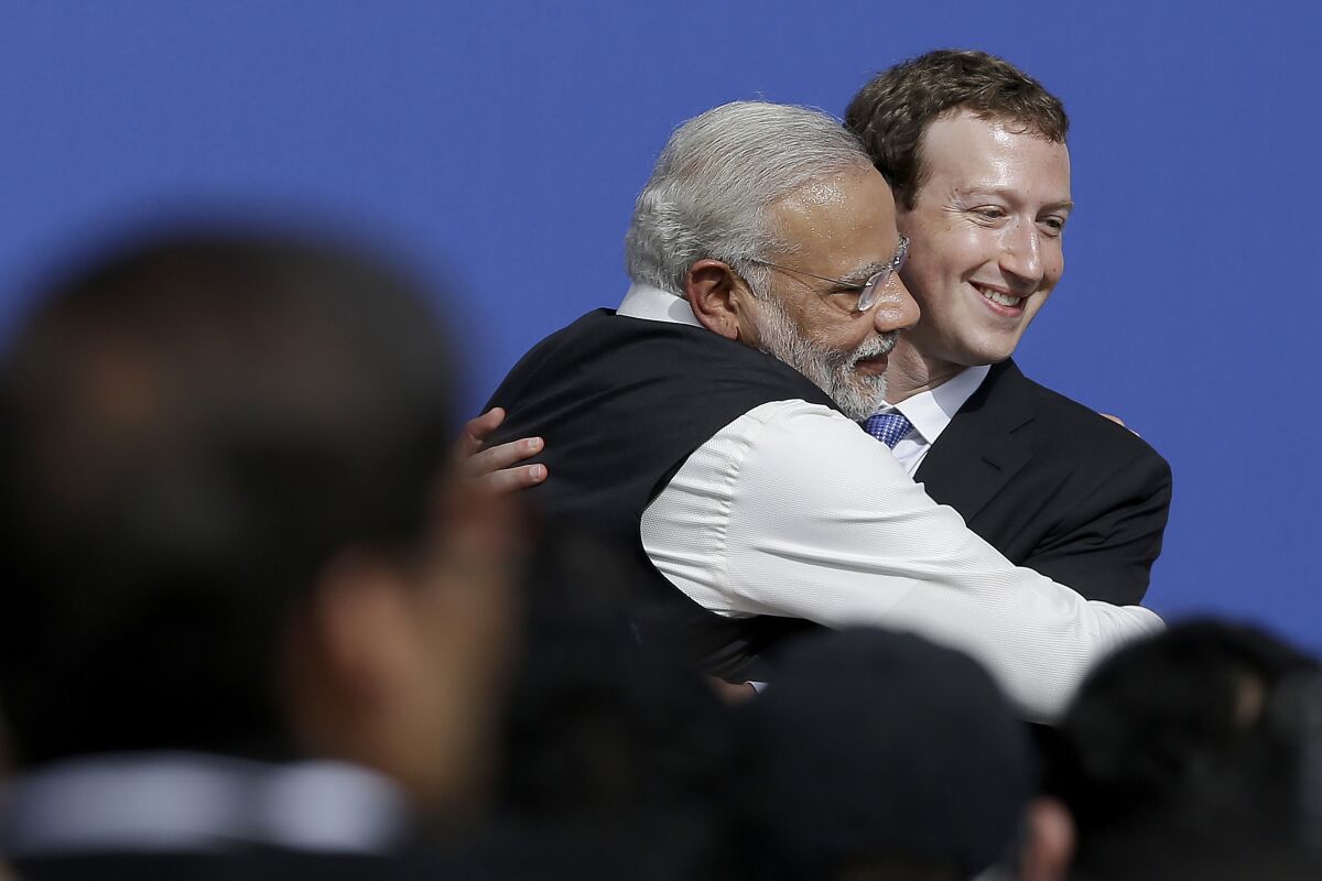 Facebook CEO Mark Zuckerberg hugs Prime Minister of India Narendra Modi.
