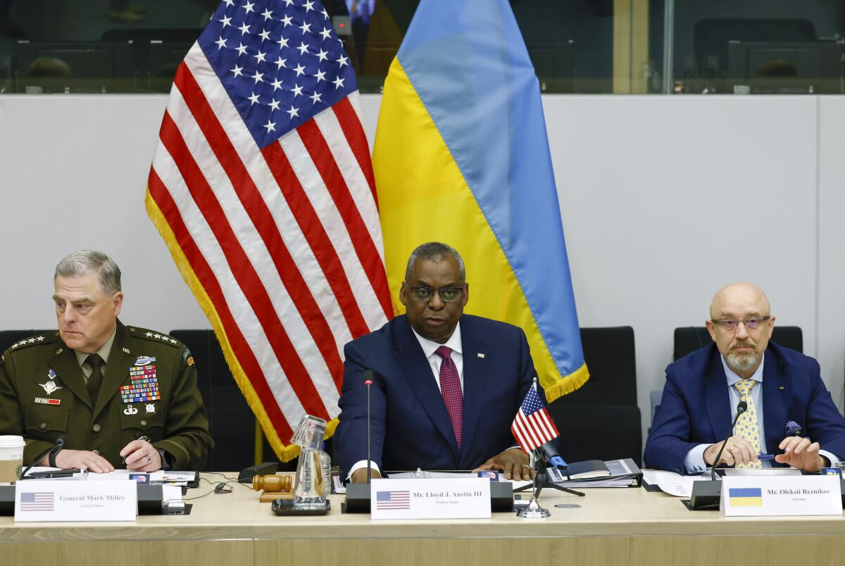 From left, U.S. Chairman of the Joint Chiefs of Staff General Mark Milley, U.S. Defense Secretary Lloyd Austin and Ukraine's Defense Minister Oleksii Reznikov attend the Ukraine Defense Contact group meeting ahead of a NATO defense ministers' meeting at NATO headquarters in Brussels, Wednesday, June 15, 2022. NATO defense ministers, attending a two-day meeting starting Wednesday, will discuss beefing up weapons supplies to Ukraine, and Sweden and Finland's applications to join the transatlantic military alliance. (Yves Herman, Pool Photo via AP)