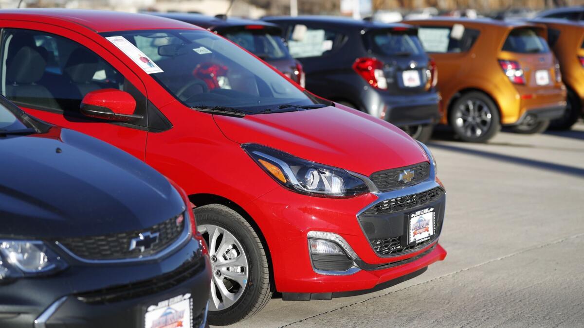 Cars await buyers at a dealership. When auto loan delinquencies rise, it's a sign of significant duress among low-income and working-class Americans.