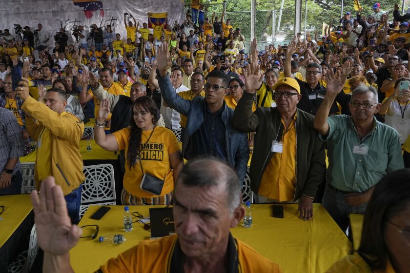 FILE - Supporters of opposition leader and former presidential candidate Henrique Capriles raise their hands as they take an oath to support him as the presidential candidate for the Primero Justicia party ahead of the opposition primary in Caracas, Venezuela, Friday, March 10, 2023. Opposition parties for years encouraged voters to boycott elections before urging them to participate in the planned October 2023 primary election to chose a single candidate to face current President Nicolas Maduro at the ballot box. (AP Photo/Ariana Cubillos, File)