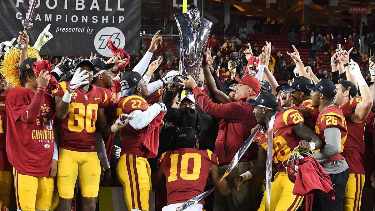 USC coach Clay Helton holds up the winner's trophy after the Trojans beat Stanford in the Pac-12 championship game on Dec. 1.