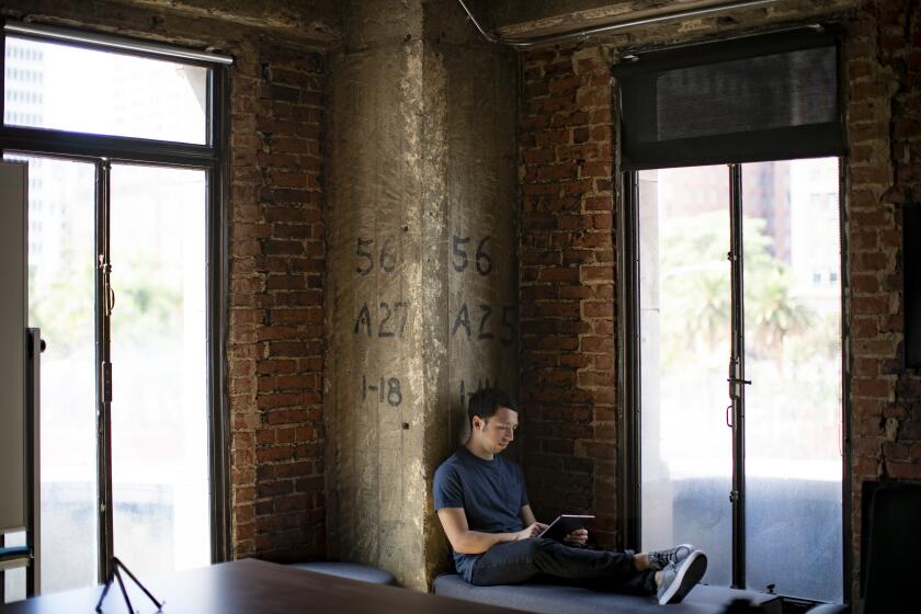 LOS ANGELES, CA - SEPTEMBER 25, 2019: Creative Director Sam Rosenthal plays his new mobile game "Where Cards Fall" on September 25, 2019 in Los Angeles, California. It's a puzzle game that explores one's life via creating and tearing down cards and was just released for Apple Arcade.(Gina Ferazzi/Los AngelesTimes)